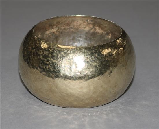 A modern planished heavy silver gilt bangle, 137 grams.